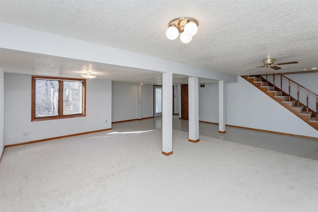 basement featuring stairs, a textured ceiling, carpet flooring, and baseboards