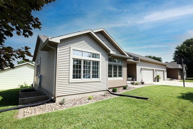 view of front of house with a garage, concrete driveway, and a front yard