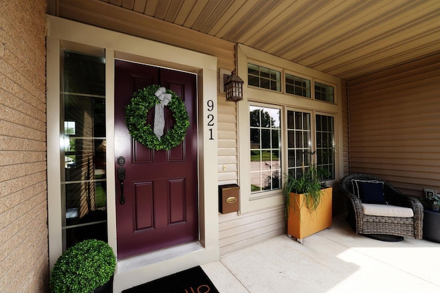 view of exterior entry with covered porch