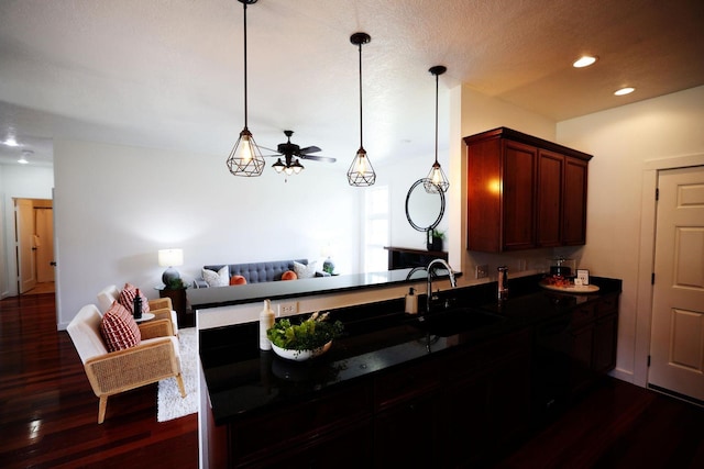 kitchen featuring dark wood-style floors, ceiling fan, open floor plan, a sink, and recessed lighting