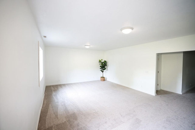 spare room with carpet flooring and baseboards