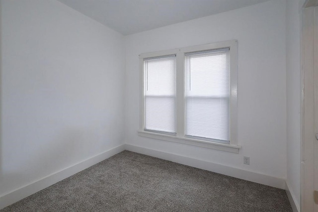 empty room with carpet and baseboards