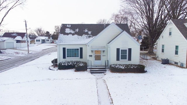 view of front of home featuring a shingled roof and cooling unit