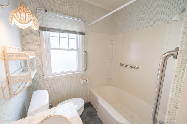 bathroom featuring bathtub / shower combination, vanity, toilet, and wallpapered walls