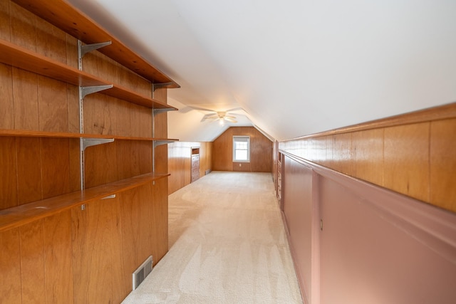 bonus room with lofted ceiling, light carpet, and visible vents