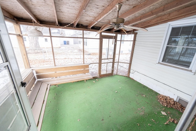 unfurnished sunroom with a ceiling fan