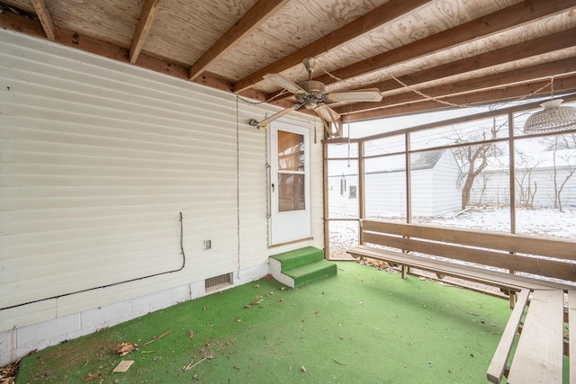 unfurnished sunroom featuring ceiling fan and beam ceiling