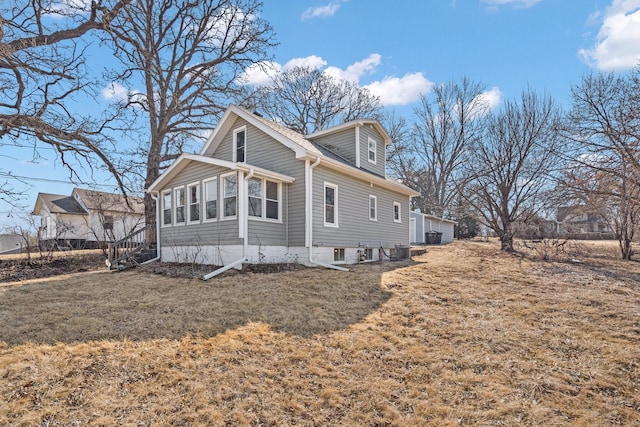 view of property exterior with a garage and central AC