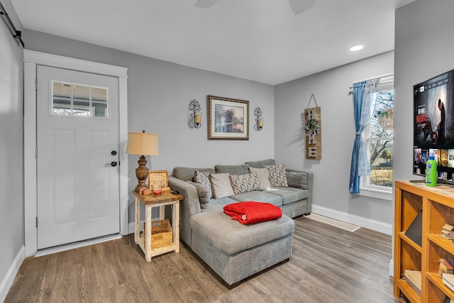 living room with recessed lighting, wood finished floors, and baseboards