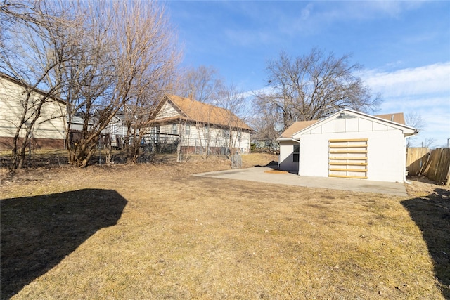 view of yard with an outdoor structure and fence