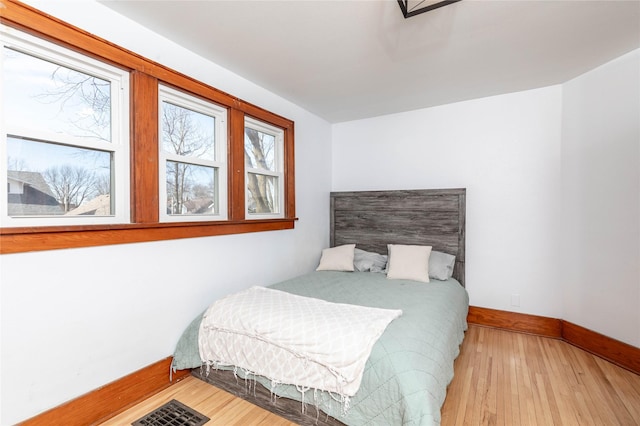 bedroom featuring baseboards and wood finished floors