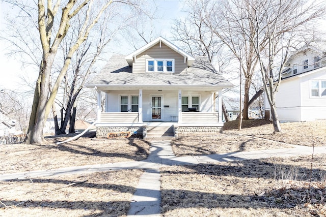 bungalow-style home featuring covered porch and a shingled roof