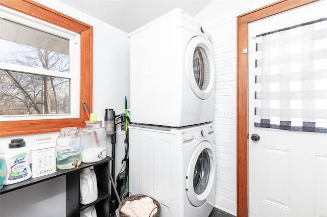 laundry area with stacked washer / drying machine and laundry area