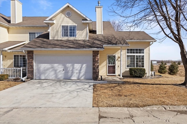 view of front of property with stone siding, a chimney, and driveway