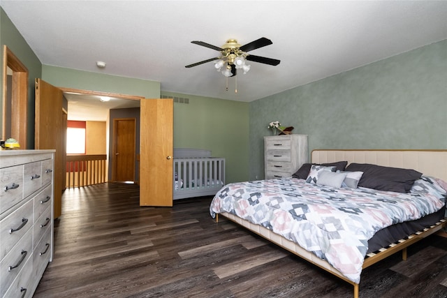 bedroom featuring dark wood-style floors, visible vents, and a ceiling fan