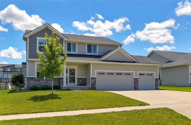 craftsman house featuring a garage, driveway, a front lawn, and stone siding