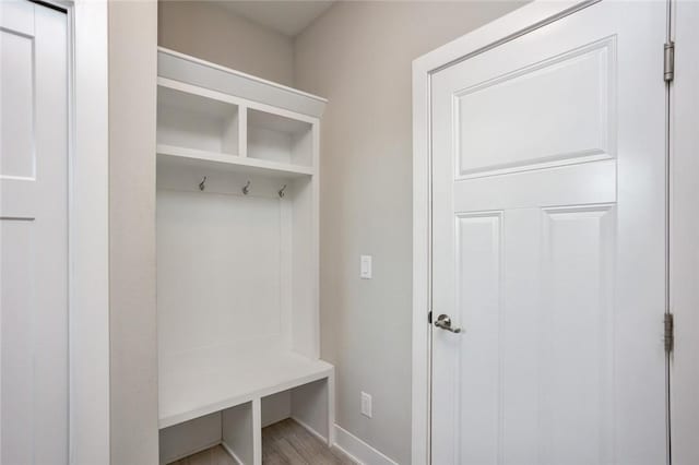 mudroom featuring light wood-style flooring and baseboards