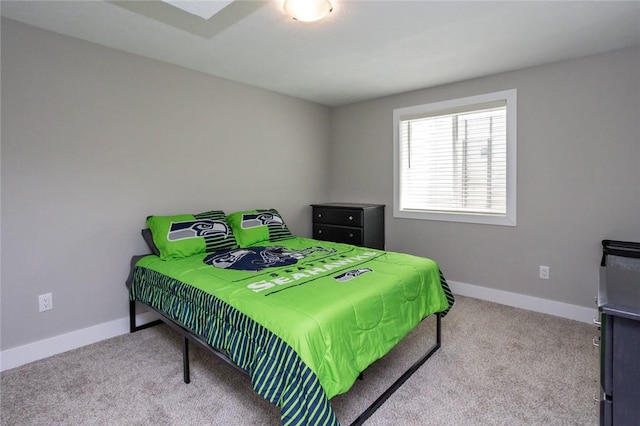 carpeted bedroom featuring baseboards