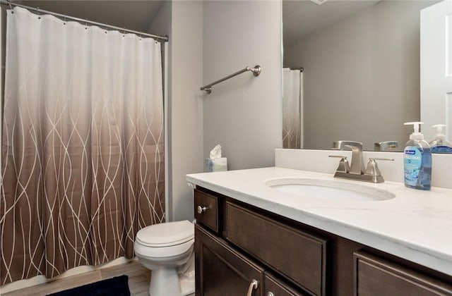 full bathroom with vanity, toilet, and wood finished floors