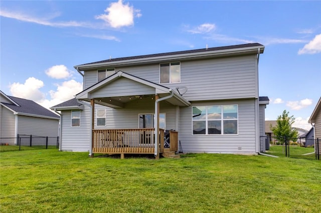 rear view of property featuring a fenced backyard, a lawn, and a deck