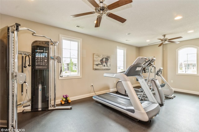 exercise room featuring recessed lighting, visible vents, ceiling fan, a textured ceiling, and baseboards