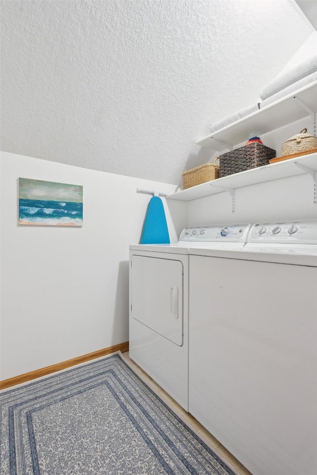 365 Williamson Ct, Pleasant Hill, IA 50327 - laundry area with baseboards, a textured ceiling, separate washer and dryer, and laundry area