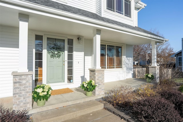 365 Williamson Ct, Pleasant Hill, IA 50327 - view of exterior entry featuring a shingled roof and covered porch