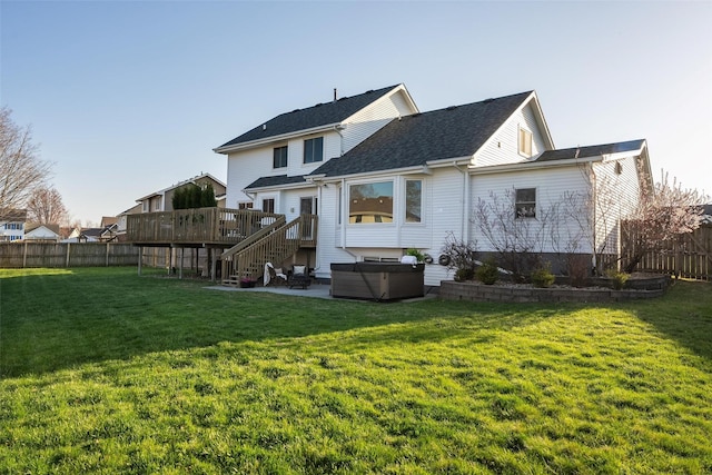 365 Williamson Ct, Pleasant Hill, IA 50327 - rear view of house with a fenced backyard, a yard, a hot tub, and a deck