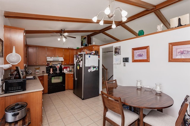 kitchen with under cabinet range hood, light countertops, freestanding refrigerator, black electric range oven, and brown cabinetry