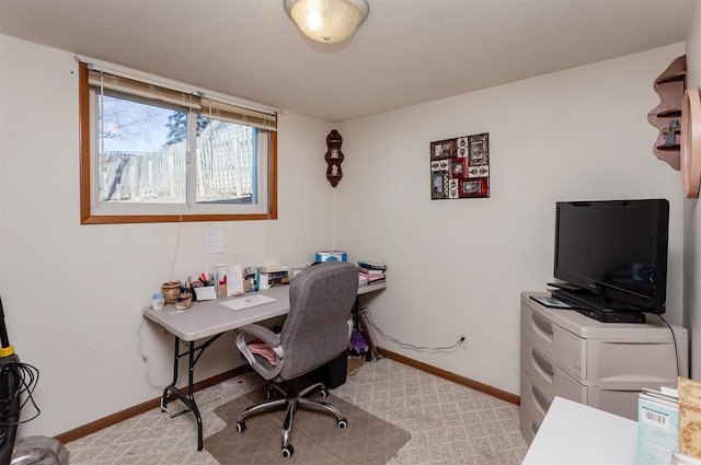 home office featuring light carpet and baseboards