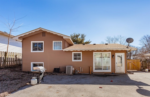 rear view of house with a gate, fence, and a patio