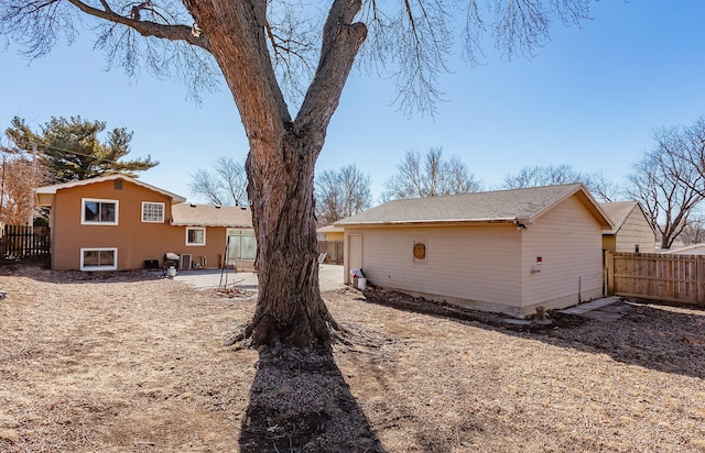 rear view of house featuring a patio and fence