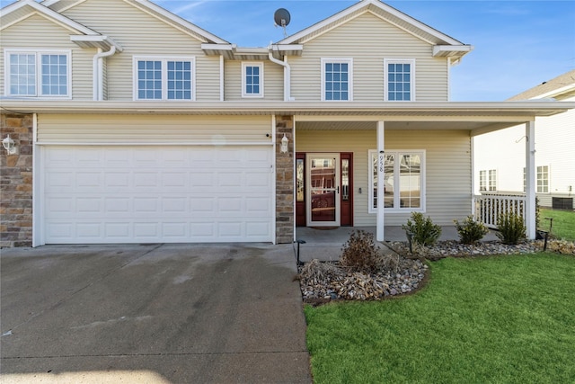 view of front facade with stone siding, covered porch, an attached garage, and concrete driveway