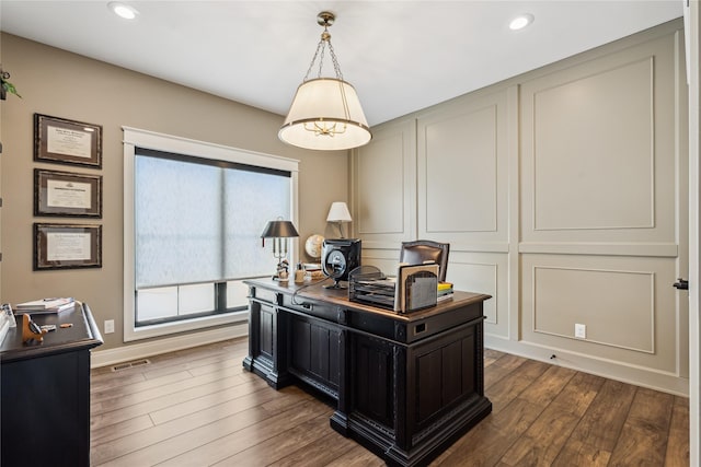 office area with baseboards, visible vents, dark wood-style flooring, a decorative wall, and recessed lighting