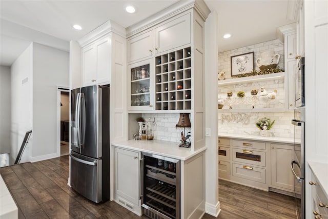 bar with recessed lighting, beverage cooler, stainless steel refrigerator with ice dispenser, decorative backsplash, and dark wood-style floors