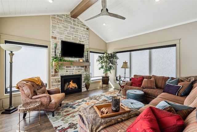 living room with beamed ceiling, a fireplace, wood finished floors, and baseboards