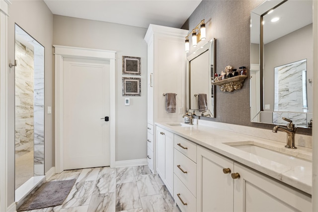 full bath featuring a sink, marble finish floor, double vanity, and a marble finish shower