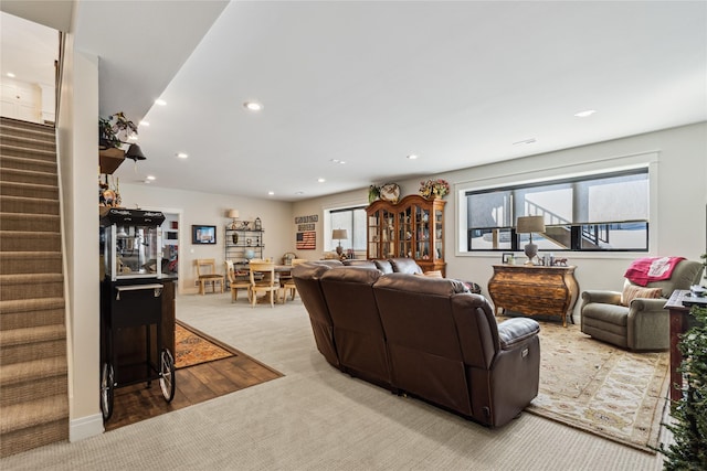 living room featuring carpet floors, recessed lighting, and stairway