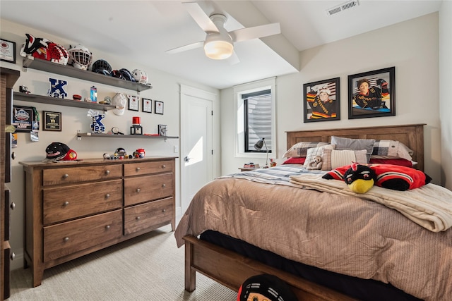 bedroom with light carpet, visible vents, and a ceiling fan