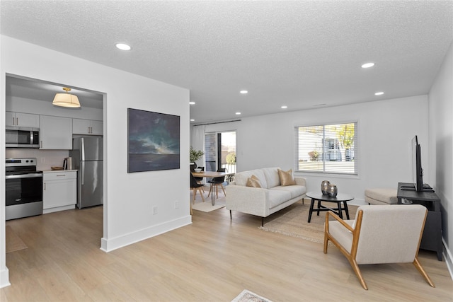 living room with recessed lighting and light wood-style floors