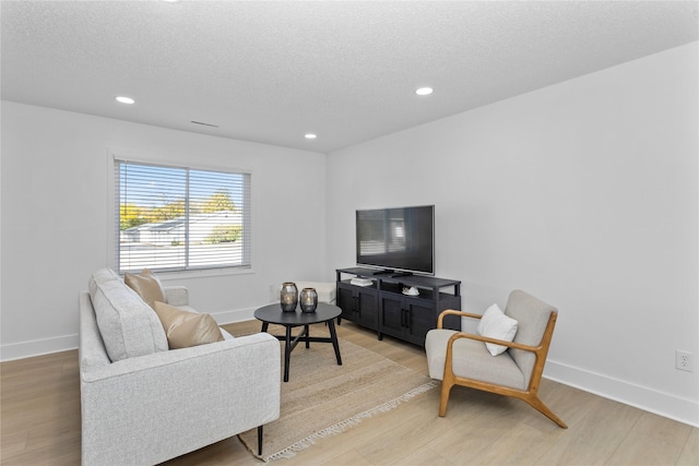 living area with light wood-style floors and baseboards