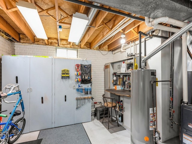 basement with water heater and brick wall