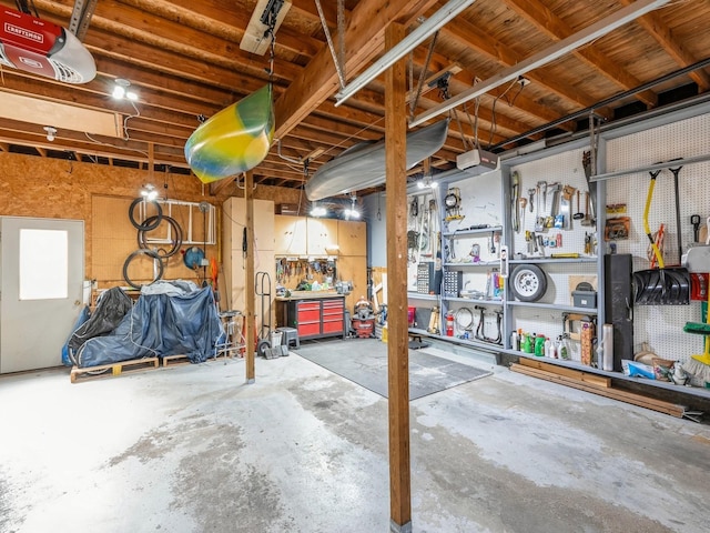 garage with a workshop area and a garage door opener