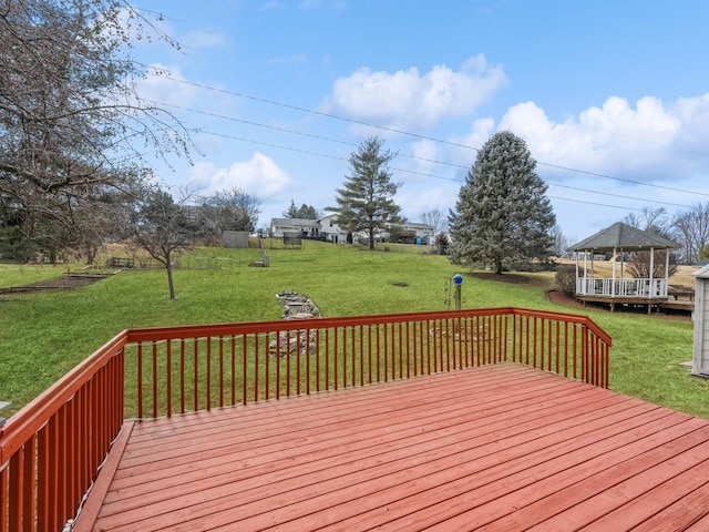 wooden deck featuring a gazebo and a lawn