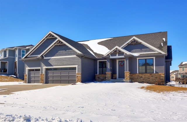 craftsman house with stone siding and an attached garage