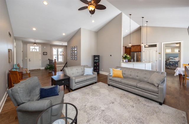 living area with high vaulted ceiling, baseboards, dark wood-style flooring, and recessed lighting