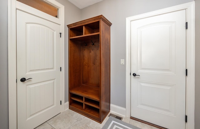 mudroom with light tile patterned floors and baseboards