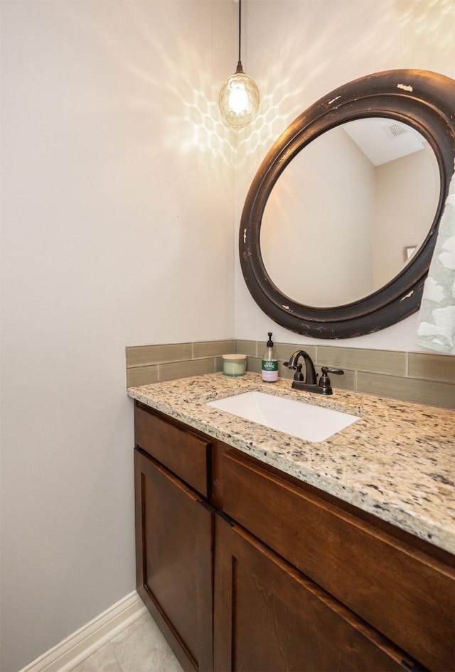 bathroom featuring tile patterned flooring, baseboards, and vanity