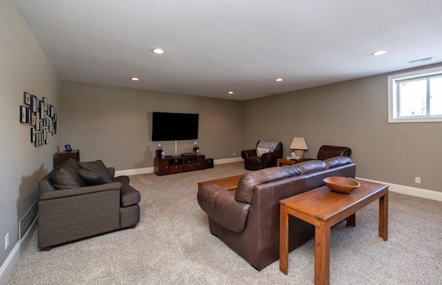 carpeted living area featuring baseboards, visible vents, and recessed lighting