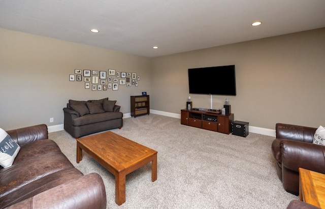 carpeted living area with recessed lighting and baseboards